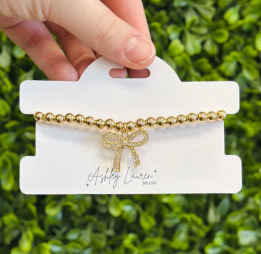 Gold Tone Beaded Bracelet With Bow Charm