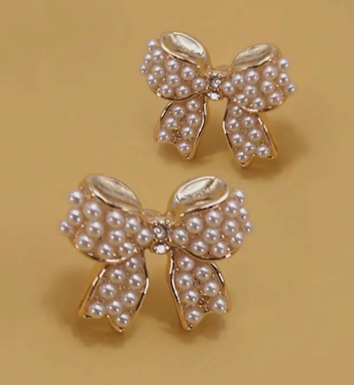 Gold bow studs with jewel & pearl detail