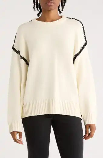 Cream sweater with black stitch design